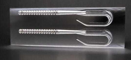 Angling A.i. open pour ribbon tail worm mold with a finished worm