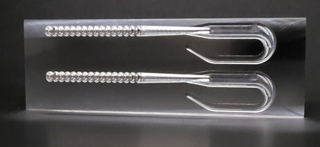Angling A.i. open pour ribbon tail worm mold with a finished worm